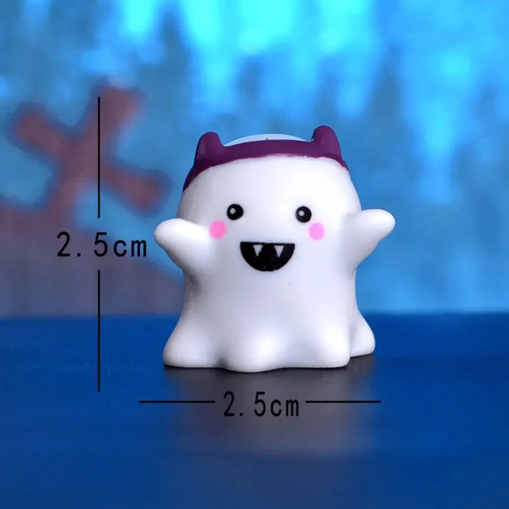 A white cartoon pumpkin bear figurine with purple ears and a black mouth, shown against a blue background.