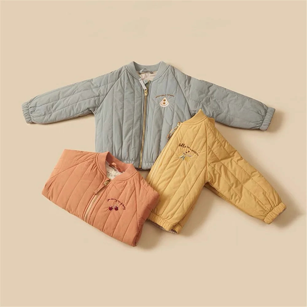 Two children's padded jackets, one blue-gray and one yellow, featuring letter prints.