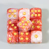 A set of ten multicolor acrylic dice with rounded corners and gold dots, arranged in a row.