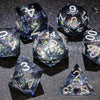 A collection of handmade liquid core polyhedral dice in various sizes and colors with a galaxy finish