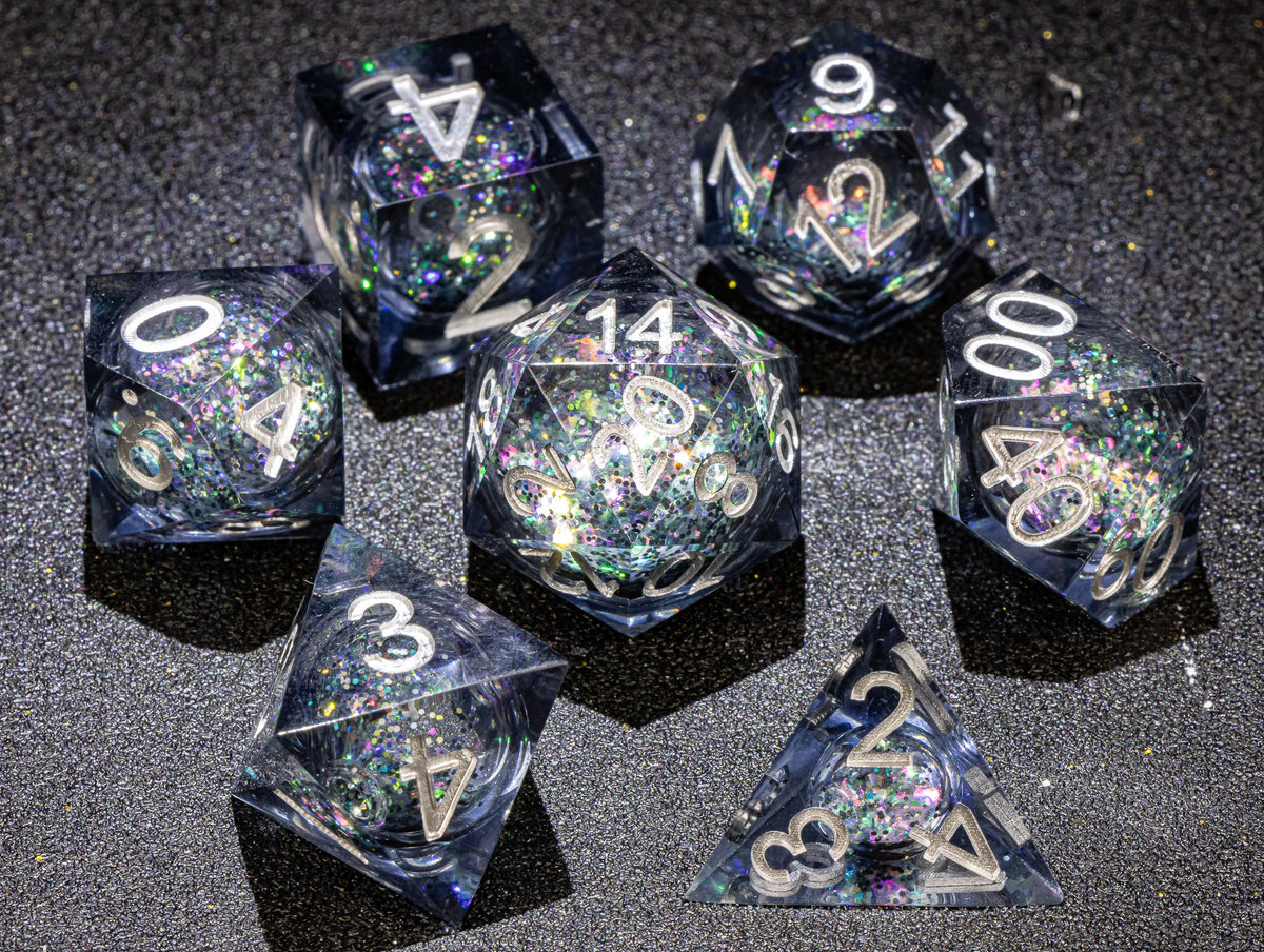 A collection of handmade liquid core polyhedral dice in various sizes and colors with a galaxy finish
