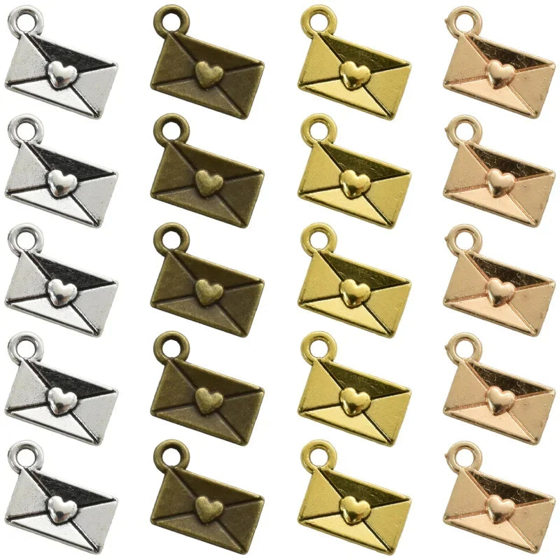 A collection of 40 vintage envelope charms in gold and rose gold finishes for jewelry making.