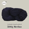 A ball of dark navy merino wool yarn labeled Lirisnly's hand-picked 300g Merino.