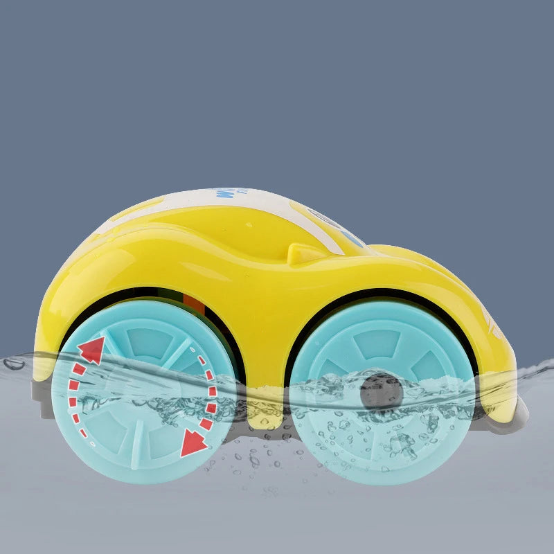 A yellow bath toy car with blue wheels is shown submerged in water.