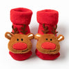 Pair of red knitted socks featuring festive reindeer designs for Christmas