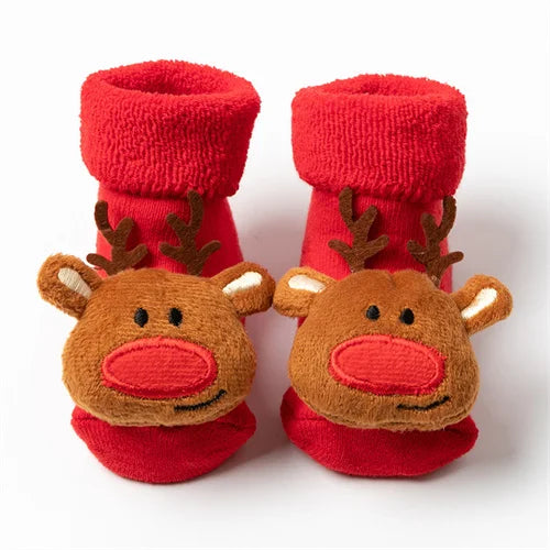 Pair of red knitted socks featuring festive reindeer designs for Christmas