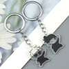 Silver keychain featuring two black anime-inspired charms with removable elements