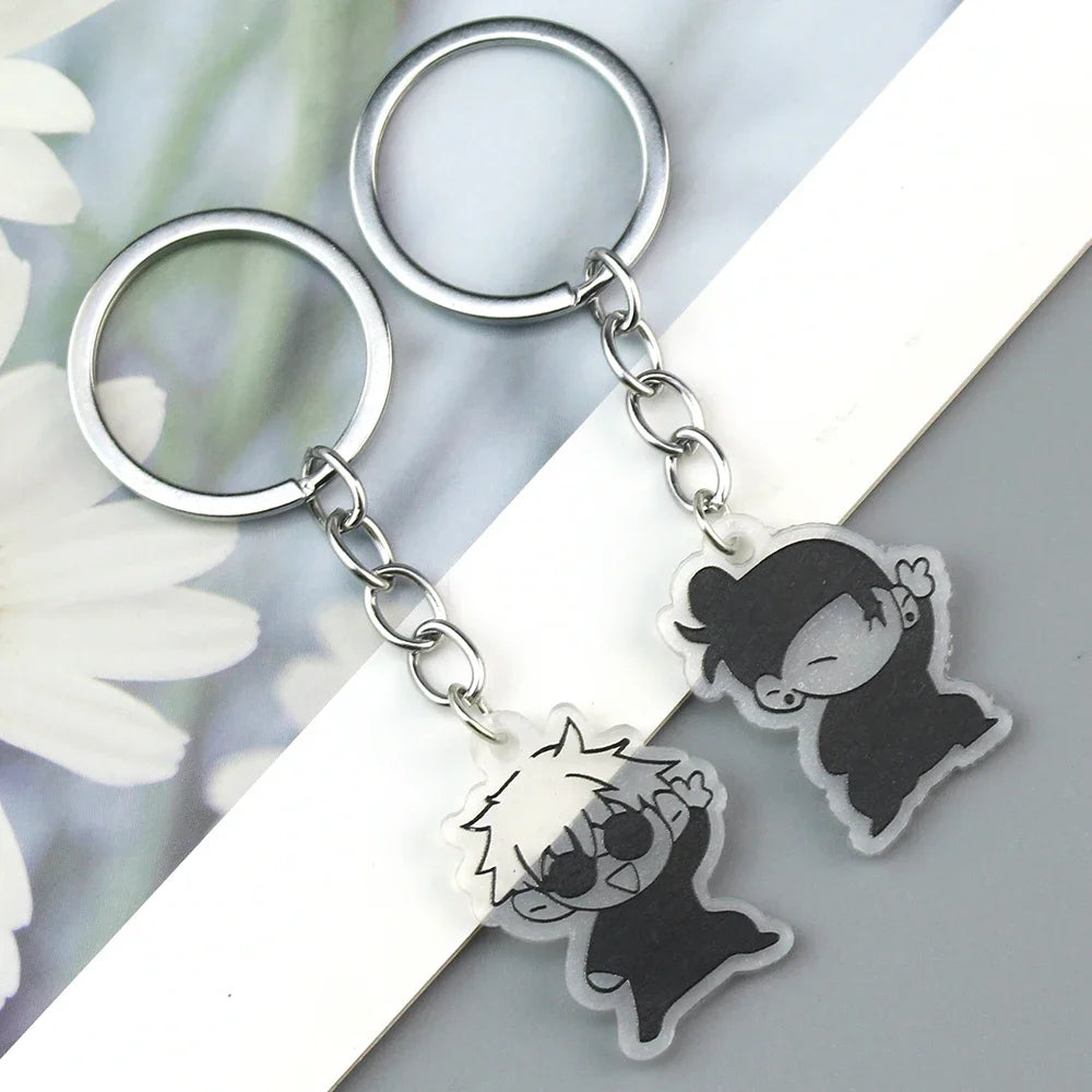 Silver keychain featuring two black anime-inspired charms with removable elements