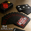 A fan of red playing cards showing a deck and individual cards on a wooden surface.