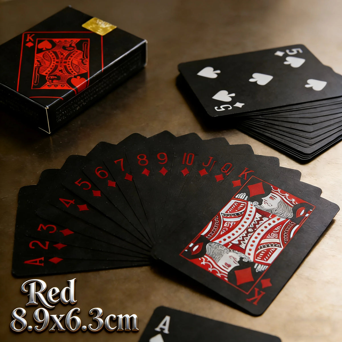 A fan of red playing cards showing a deck and individual cards on a wooden surface.