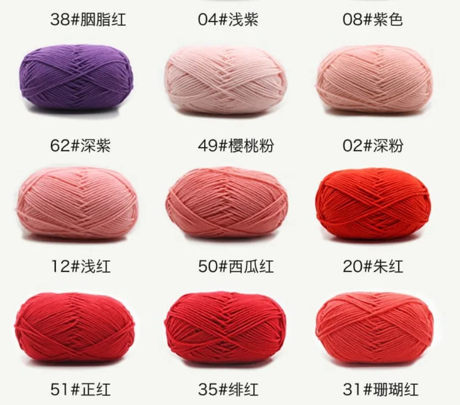 A collection of red and pink yarn balls showing various colors and textures for knitting and crochet projects.