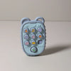 A light blue silicone teether shaped like a phone with various buttons for babies.
