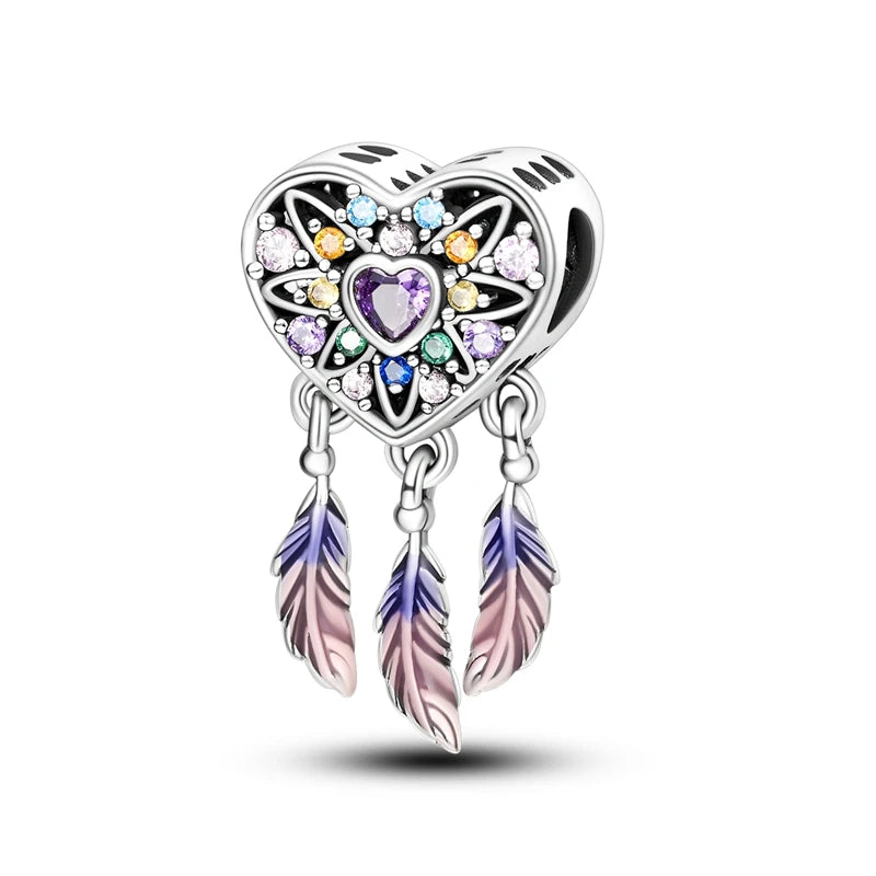 A heart-shaped sterling silver charm bead featuring pink zircon stones and attached feather elements.