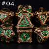 A set of seven polyhedral metal dice in various shades of bronze and green, arranged on a dark surface.