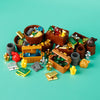 A collection of building blocks, coins, and gems in various colors and shapes arranged on a teal surface.