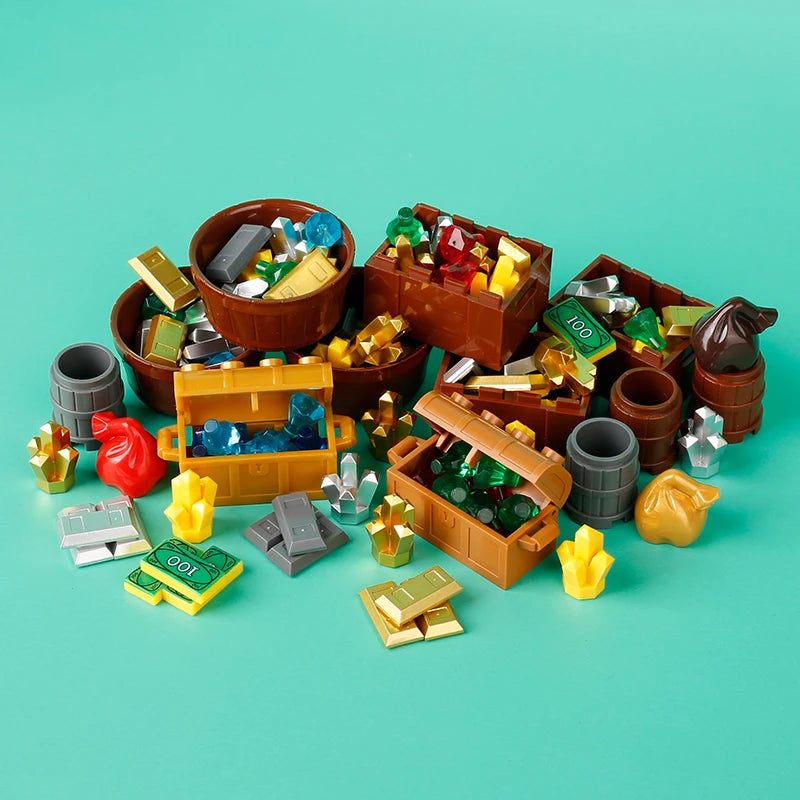 A collection of building blocks, coins, and gems in various colors and shapes arranged on a teal surface.