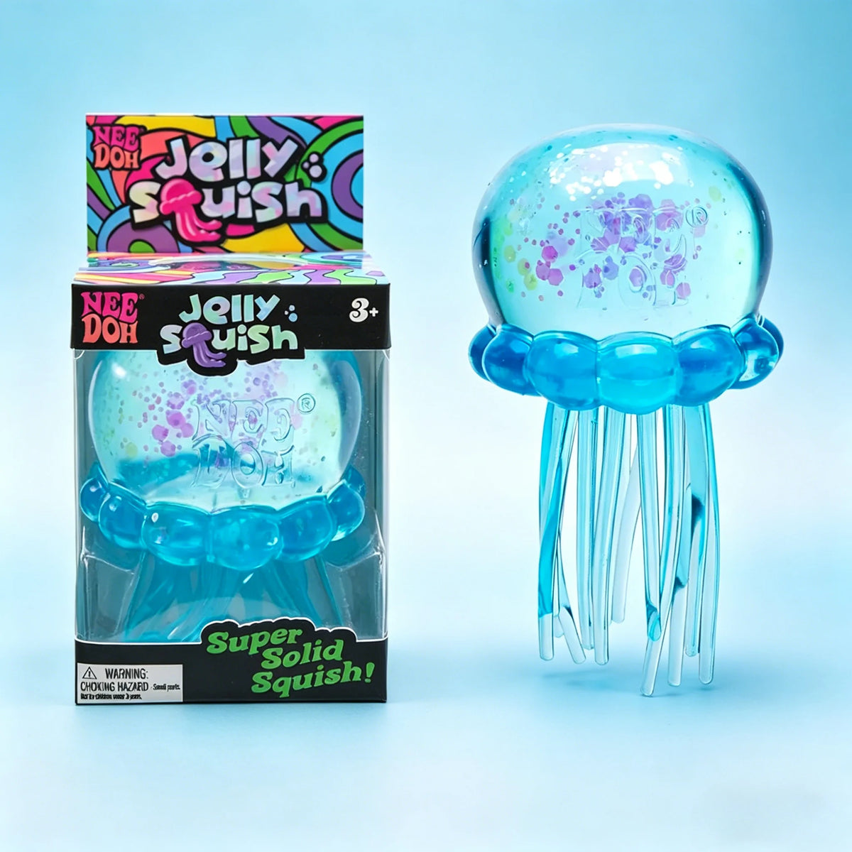 A box and a clear squishy toy of a blue jellyfish shape with tentacles on a light blue background.
