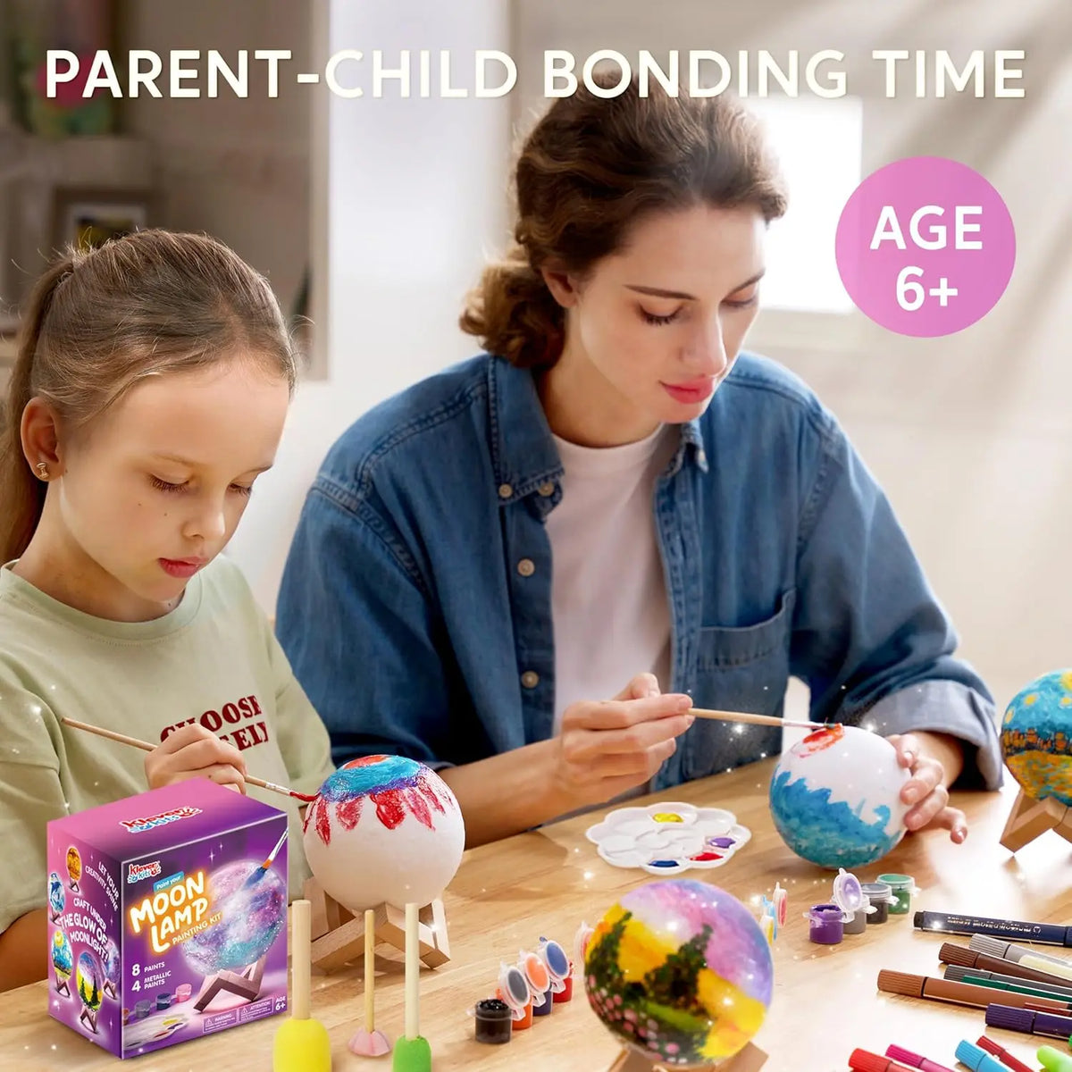 A mother and daughter are engaged in parent-child bonding time crafting a DIY 3D Moon Night Light kit with colorful paint and