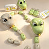 A magnetic snake toy featuring a head and body segments in light green and gray, arranged in a circular path.