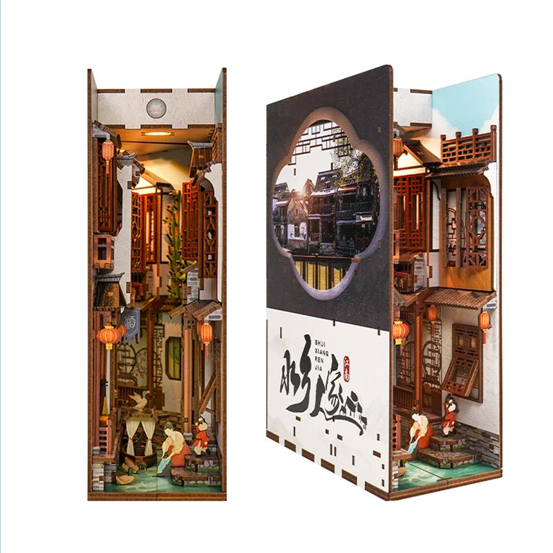 A DIY book nook kit featuring a detailed miniature scene with traditional architecture and LED lighting.