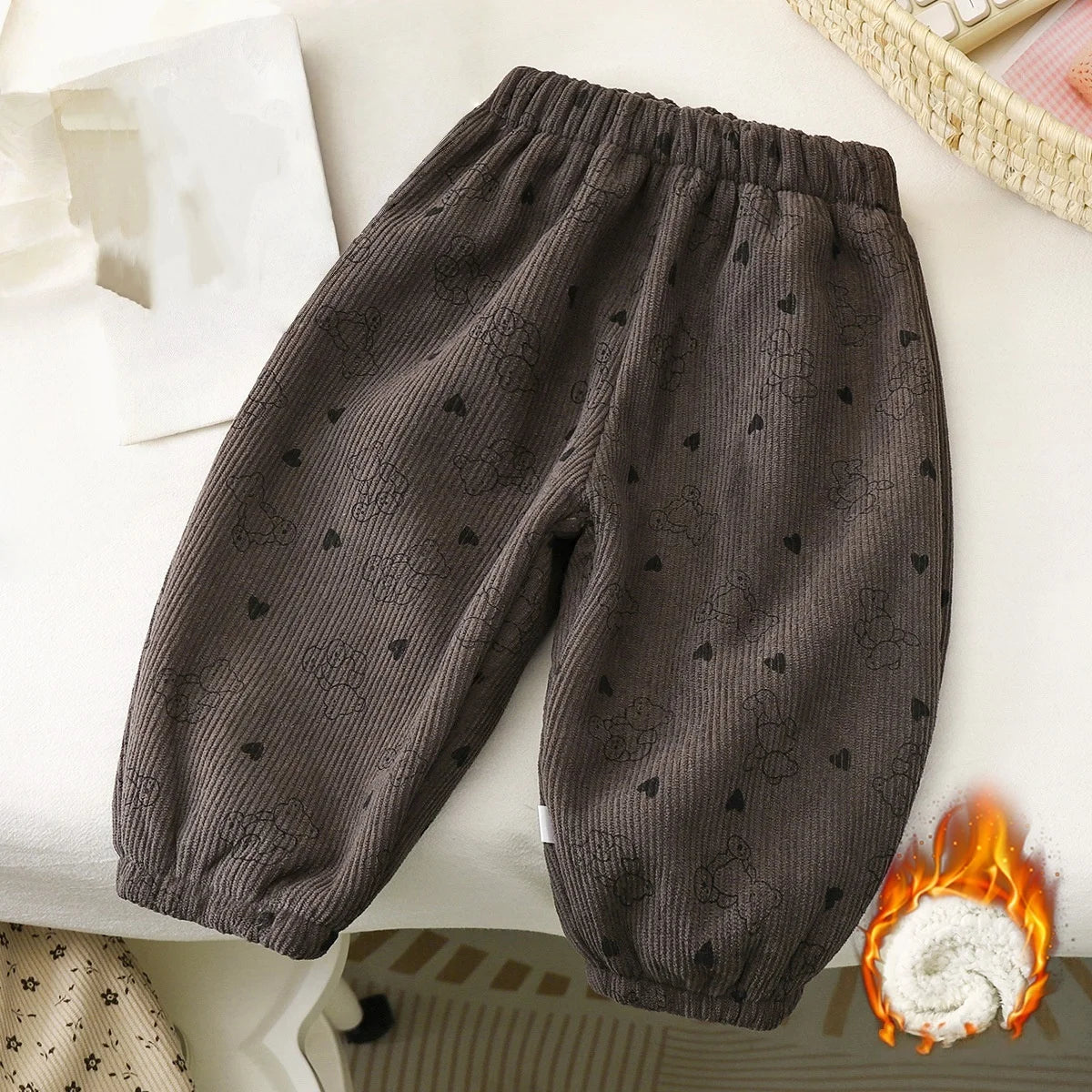 Dark gray fleece-lined pants with a subtle heart pattern, shown flat lay on a white surface.