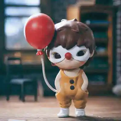 A small mischievous figure from the POP MART Hirono series with brown hair and large white eyes holding a red balloon.