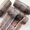 A collection of vintage patterned washi tape rolls and strips for journaling and scrapbooking