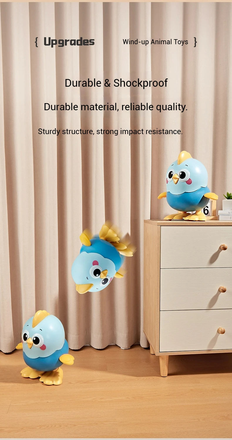A blue and yellow wind-up animal toy chick is displayed on a wooden dresser against a light curtain backdrop.