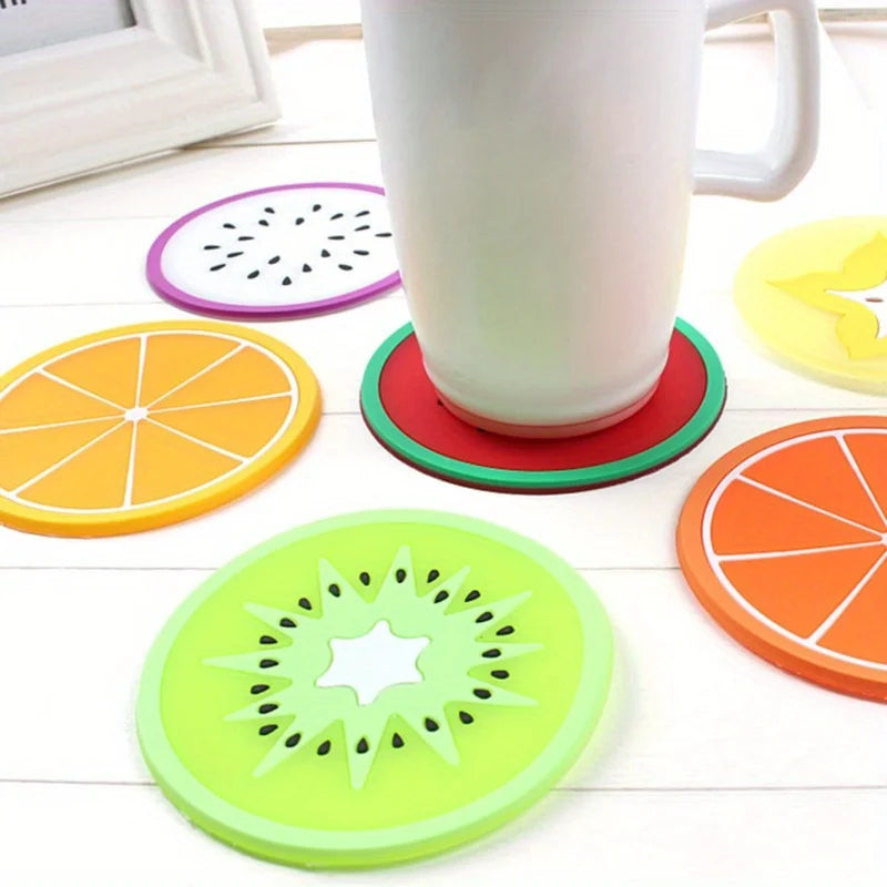A set of colorful fruit pattern PVC coasters, including orange, lime green, and purple designs.