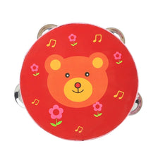 A red wooden tambourine with a cartoon bear face design featuring pink flowers and musical notes.