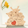 A wooden puzzle decoration featuring an elk family with names like James, William, Emma, Ava, and Olivia.