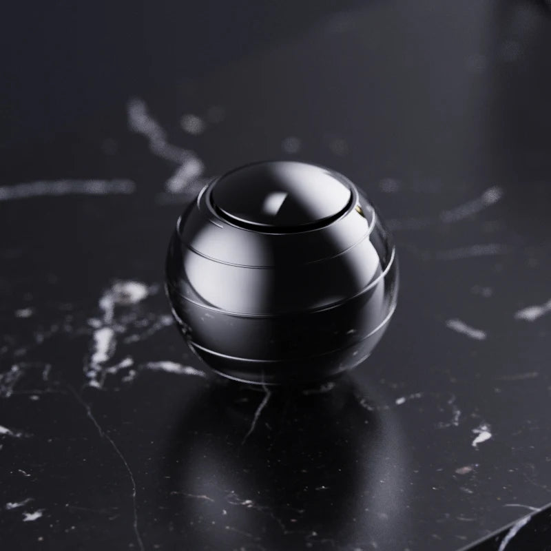A close-up shot of a polished, silver metal fidget spinner resting on a dark marble surface.