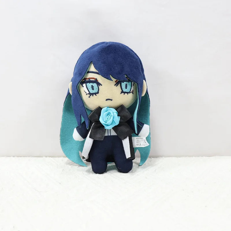 A plush doll of Ado Hibana with blue hair and large blue eyes wearing a dark outfit and a blue flower