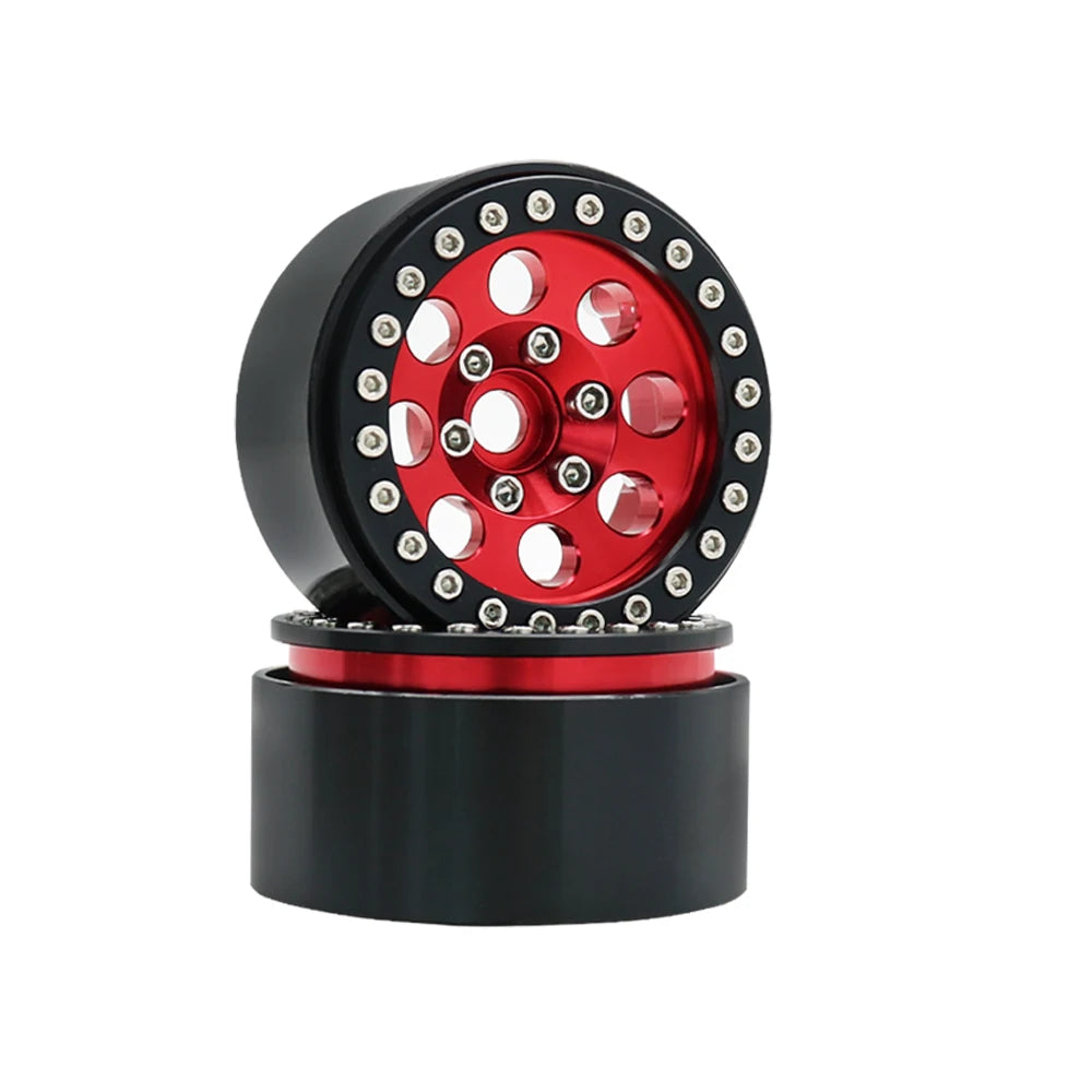 A black beadlock wheel with a red center and removable hex hub for an RC crawler.