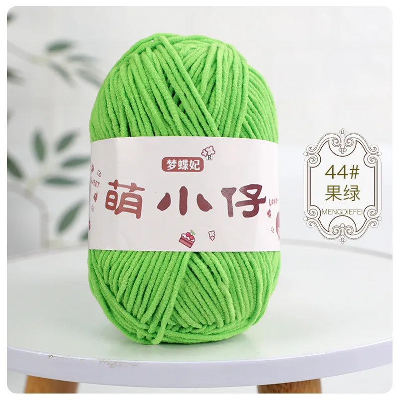 A ball of bright green chenille yarn with Chinese characters labeled for knitting and crochet.