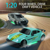 A teal drift vehicle is shown driving on a racetrack, with another car in the background.
