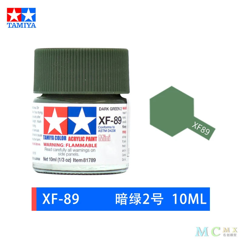 A glass jar of dark green acrylic paint labeled XF-89 for model kits and miniatures.