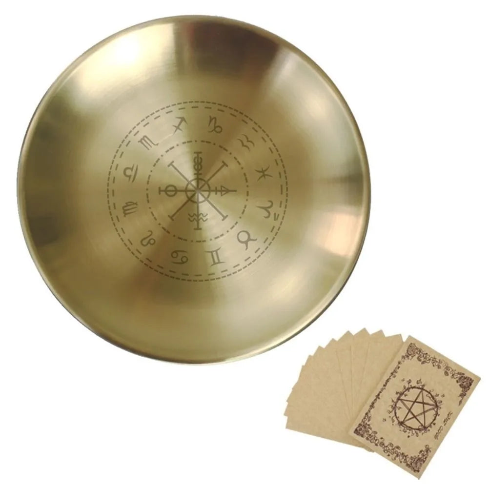 A brass pentagram altar plate with etched astrological symbols and ritual parchment cards.