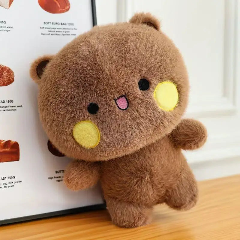 A brown fluffy panda plush toy sitting next to a list of ingredients.