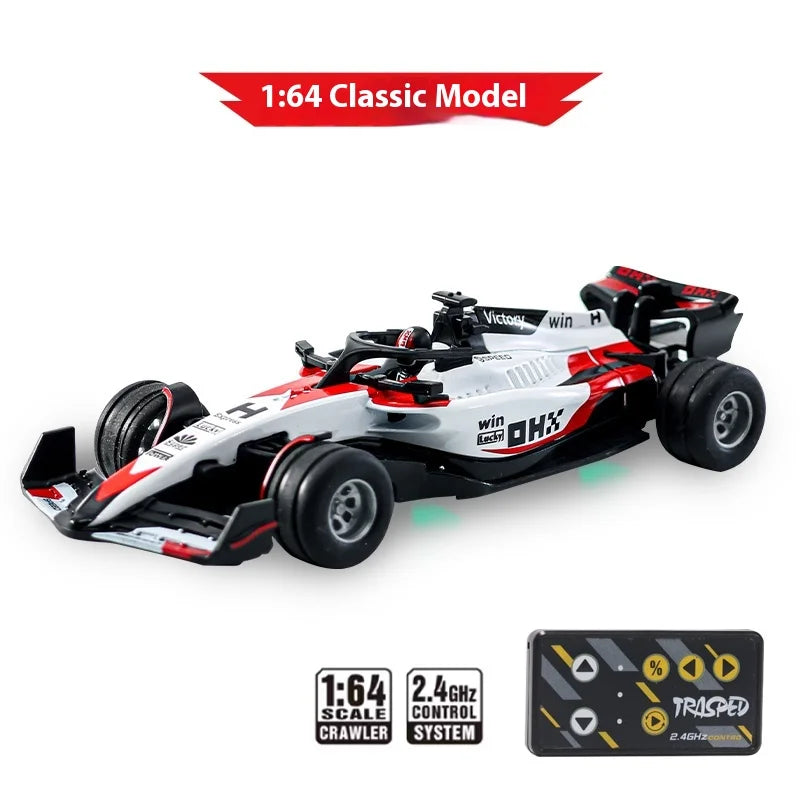 A white and red 1:64 scale RC drift car model with wheels and control system components.
