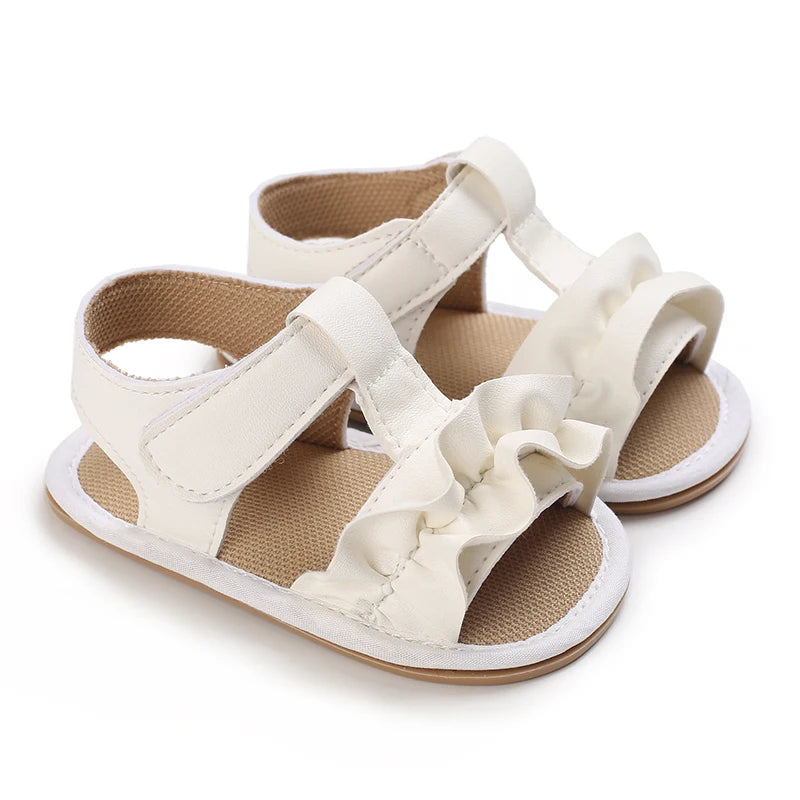 A pair of cream-colored breathable baby first walker sandals with soft anti-slip soles.