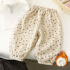 Light beige fleece-lined pants with a small floral print laid out on a white surface.
