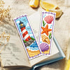A set of six cross-stitch bookmarks featuring lighthouse, starfish, and seashell designs on white fabric.