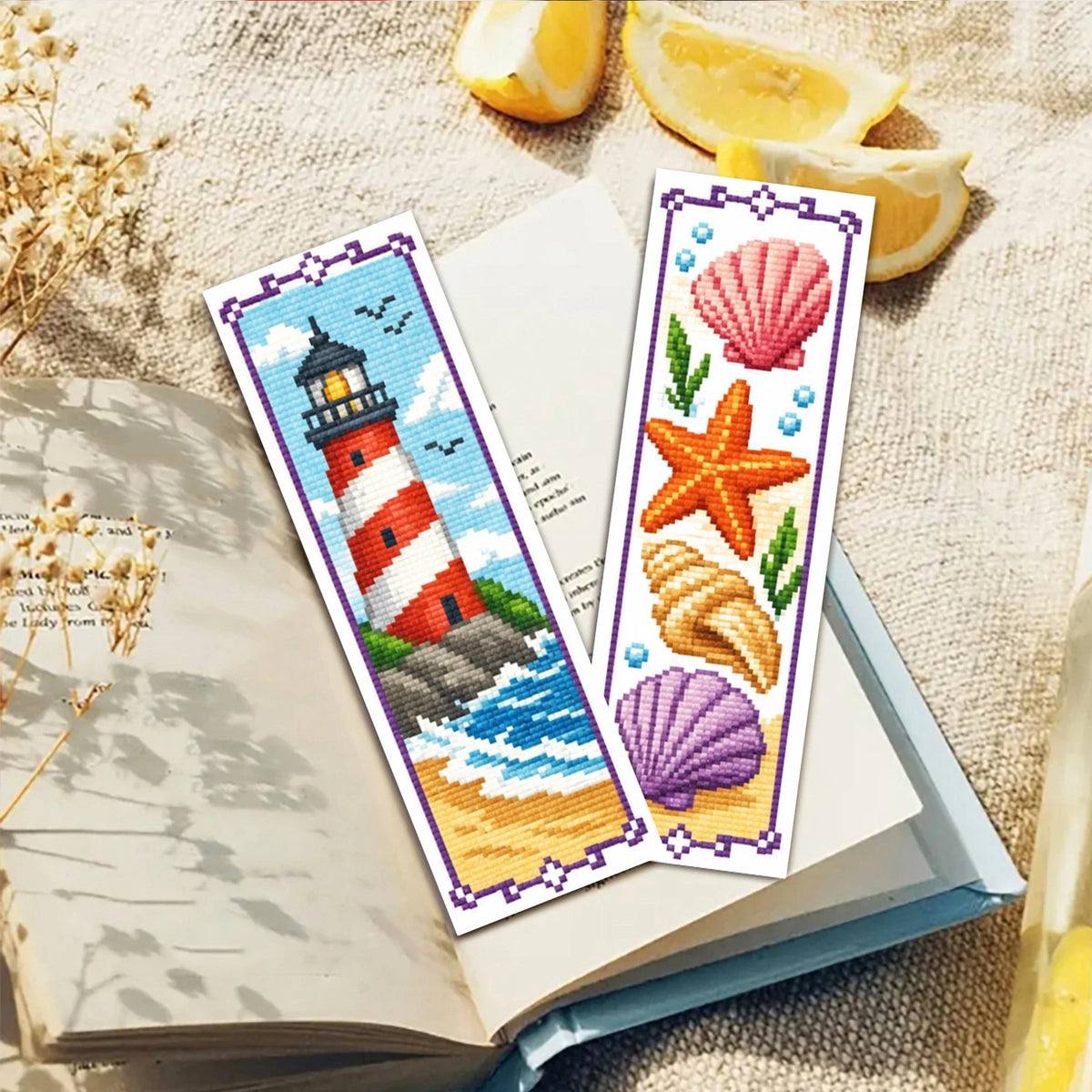 A set of six cross-stitch bookmarks featuring lighthouse, starfish, and seashell designs on white fabric.