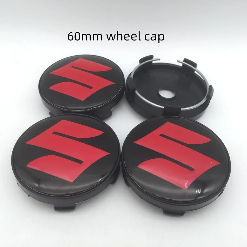 Two black wheel caps with red Suzuki logos shown on a white background.