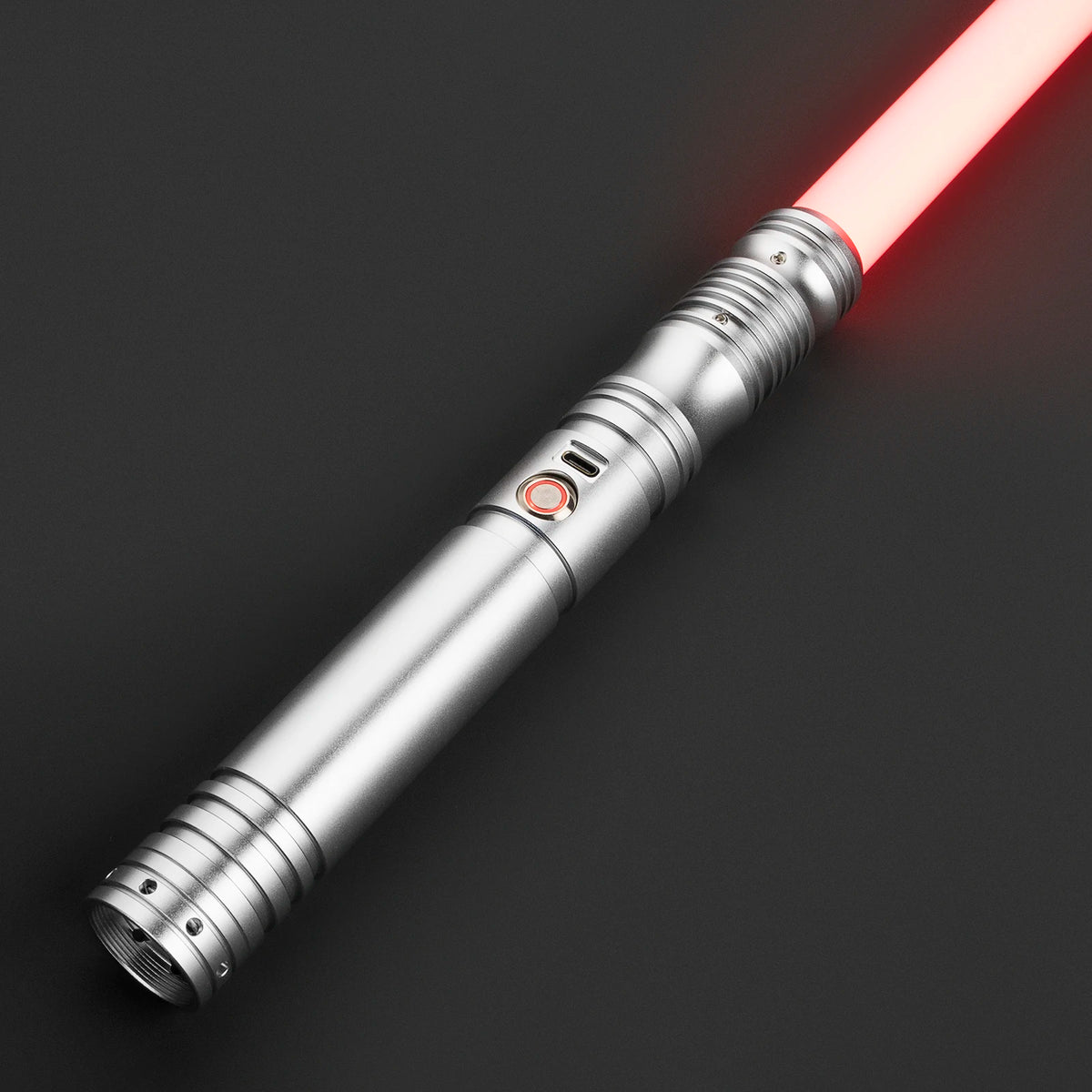 A silver lightsaber with a glowing red blade is shown diagonally against a dark background.