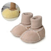 Pair of beige suede baby booties with plush fur lining shown next to a close-up of the fluffy lining.
