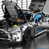 A detailed model kit of a sports car with an attached simulated racing tail wing and interior components.