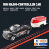 A black mini radio-controlled car with a red container, showing the remote control device.