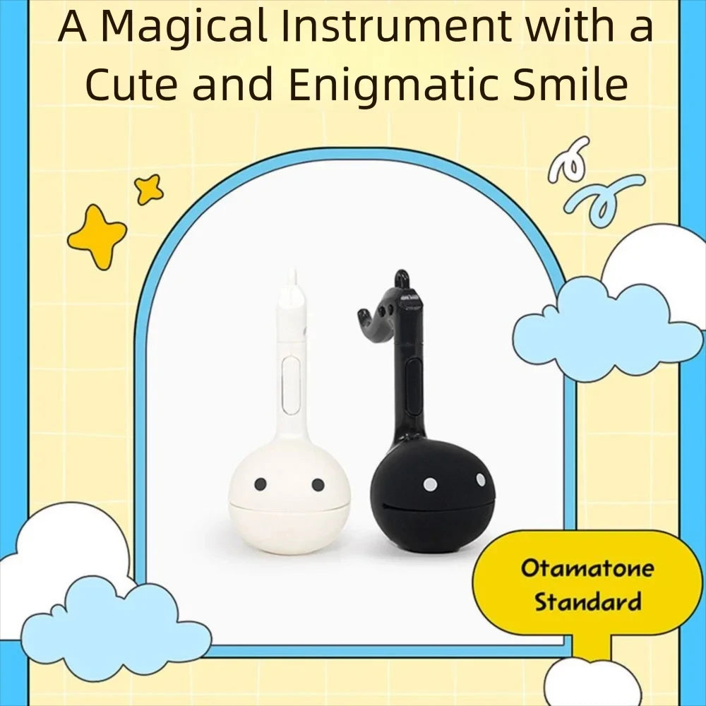 A white and black Otamatone instrument toy with a cute and enigmatic smile is shown against a light yellow background.